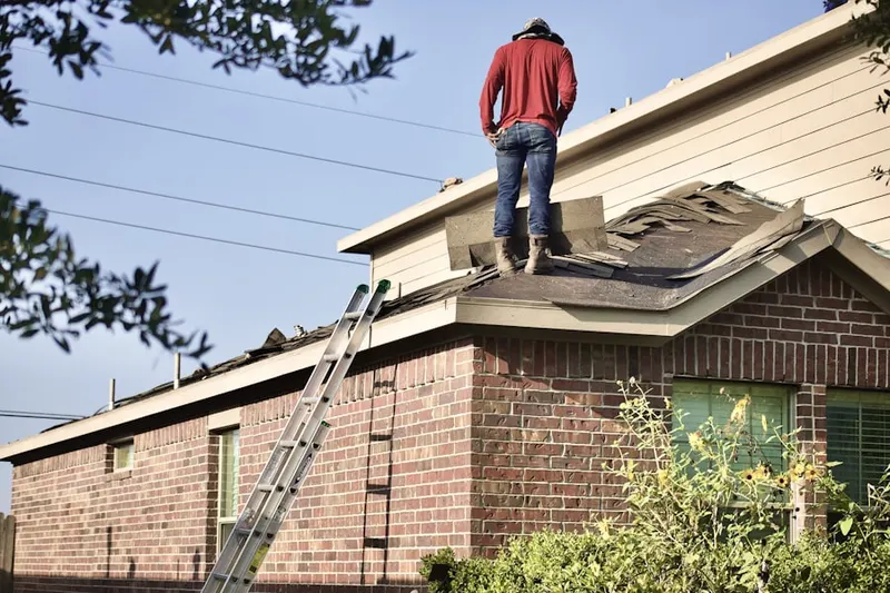 Professional roofer working on a residential roof in Garrison Farms